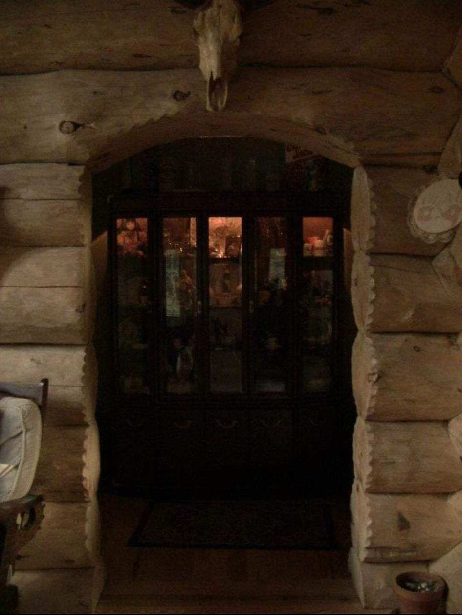 Handcrafted log archway and cabinet area
